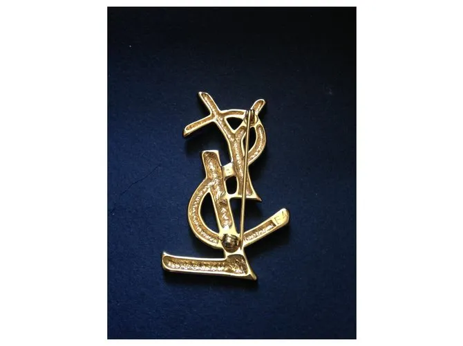 Yves Saint Laurent Alfileres y broches Dorado 